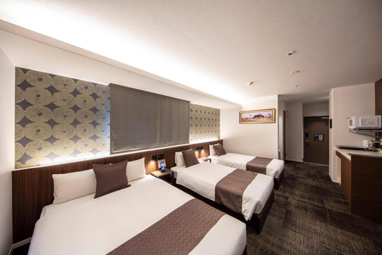 GRAND BASE Okayama Ekimae Aparthotel Bagian luar foto